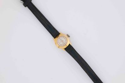 a close up of a wrist watch on a white surface