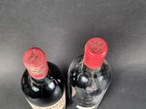 two bottles of wine sitting next to each other on a table