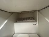 an image of a small white refrigerator with the door open