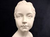 a close up of a statue of a woman ' s face