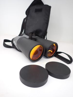 a pair of binoculars sitting on top of a table next to a bag