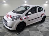 a picture of a small white car parked in a garage