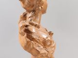 sculpture of a woman ' s head on a pedestal with a glass base