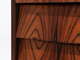a close up of a wooden chest of drawers on a white background