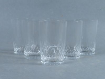 four clear glasses sitting on top of a table next to each other