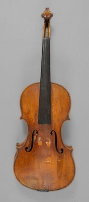 a close up of a violin on a gray surface