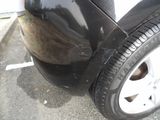 a close up of a black car with a flat tire