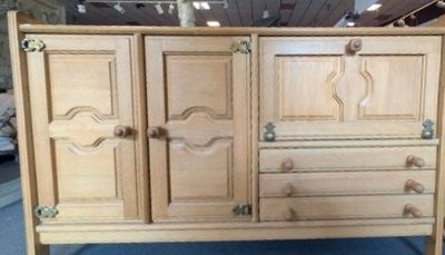 a wooden cabinet with doors and drawers on it