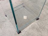 a glass display case on the floor of a living room