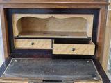 a wooden desk with a drawer on top of it