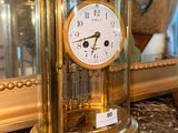 a gold clock sitting on top of a marble counter