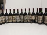 several bottles of wine are lined up in a row on a table