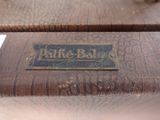 a close up of a wooden bench with a sign on it