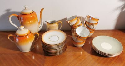 many plates and cups on a table with a teapot