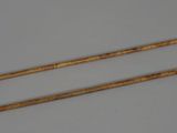 a pair of wooden sticks that are next to each other