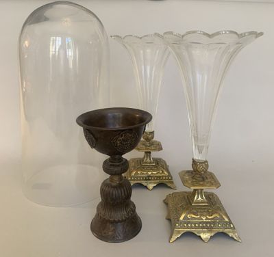 three glass vases and a candle holder on a table