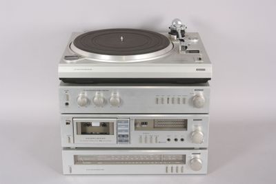 three turntables stacked on top of each other on a white surface