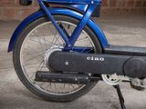 a close up of a blue bike parked in a garage