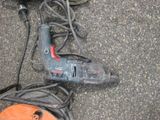 a corded cord and a corded drill on the ground