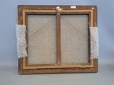 an old picture frame with a piece of fabric hanging from it ' s sides