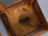 a wooden box with a green object inside of it