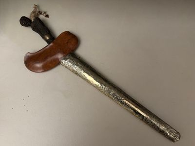 a picture of a knife with a wooden handle on a table
