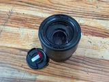 a black camera lens sitting on a wooden table