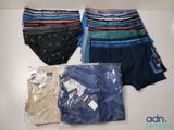 several men ' s underwear are wrapped in plastic bags on a table