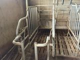 a metal grate in the middle of a room filled with metal pipes