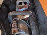 a black bag with tools in it sitting on the floor