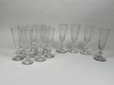 plusieurs verres à vin vides sont alignés sur une surface blanche