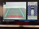 two pictures of a car on the screen of a tv