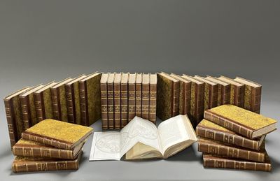 a pile of books sitting on top of a table next to each other