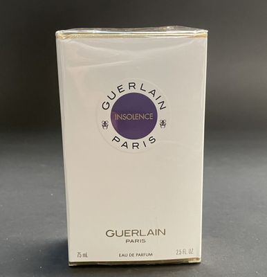 a box of perfume sitting on a table on a table