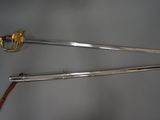 two swords with a gold handle and a wooden handle