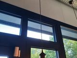 a light that is hanging from the ceiling above a window