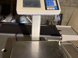 an image of a scale on a conveyor belt in a warehouse
