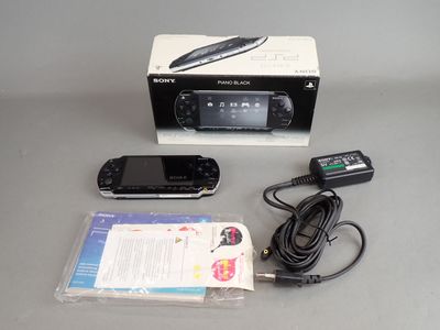 a box with a remote and a cell phone in it