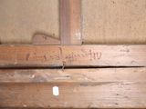 a close up of a piece of wood with writing on it
