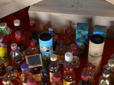 many bottles of alcohol on a table with a wooden box