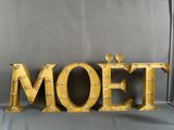 a close up of a metal sign that says moet