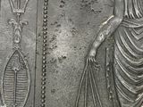 an image of a silver coin with a woman holding a fish