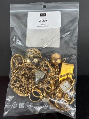 a close up of a bag of gold jewelry on a table