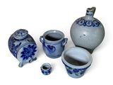 a group of blue and white vases on a white surface