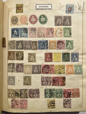 an open book with a bunch of stamps on it sitting on top of a table