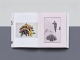 an open book with a picture of a woman and a bunch of vegetables