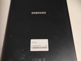 the back of a black samsung tablet sitting on top of a desk