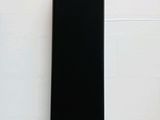 the back of a black cell phone sitting on top of a table