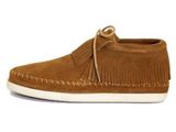 a close up of a pair of brown moccali shoes on a white background
