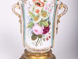 a vase that has a bird on top of it